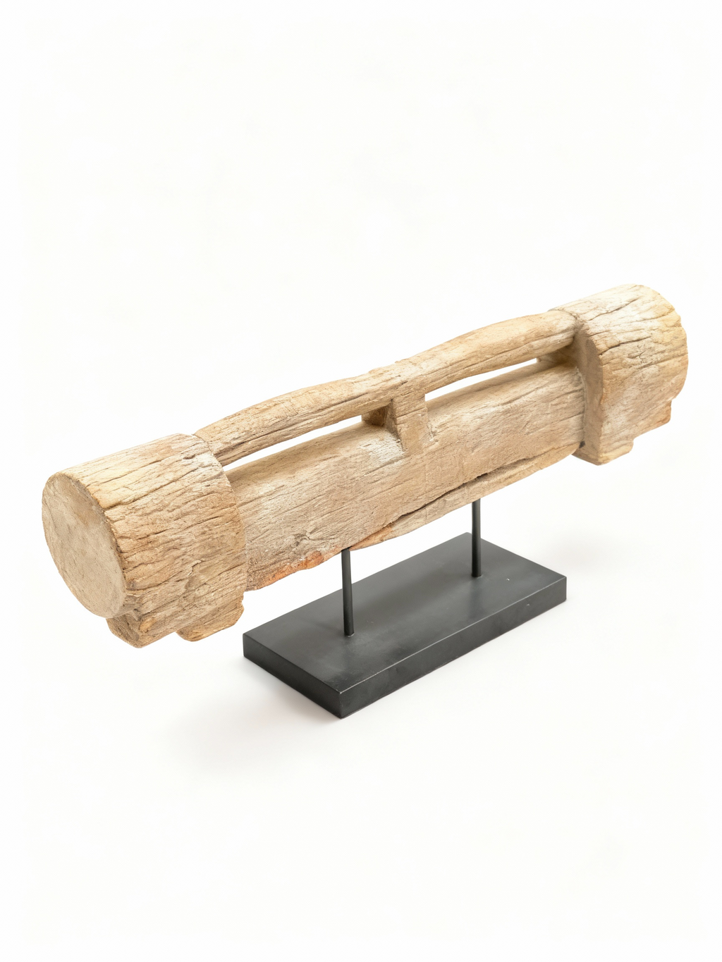 Antique solid wood door lintel fragment with cylindrical forms and whitewashed patina, mounted on a modern black metal pedestal