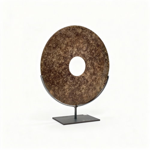 Chinese Bi disc sculpture in earthen speckled patina on a matte black metal stand, 30 cm