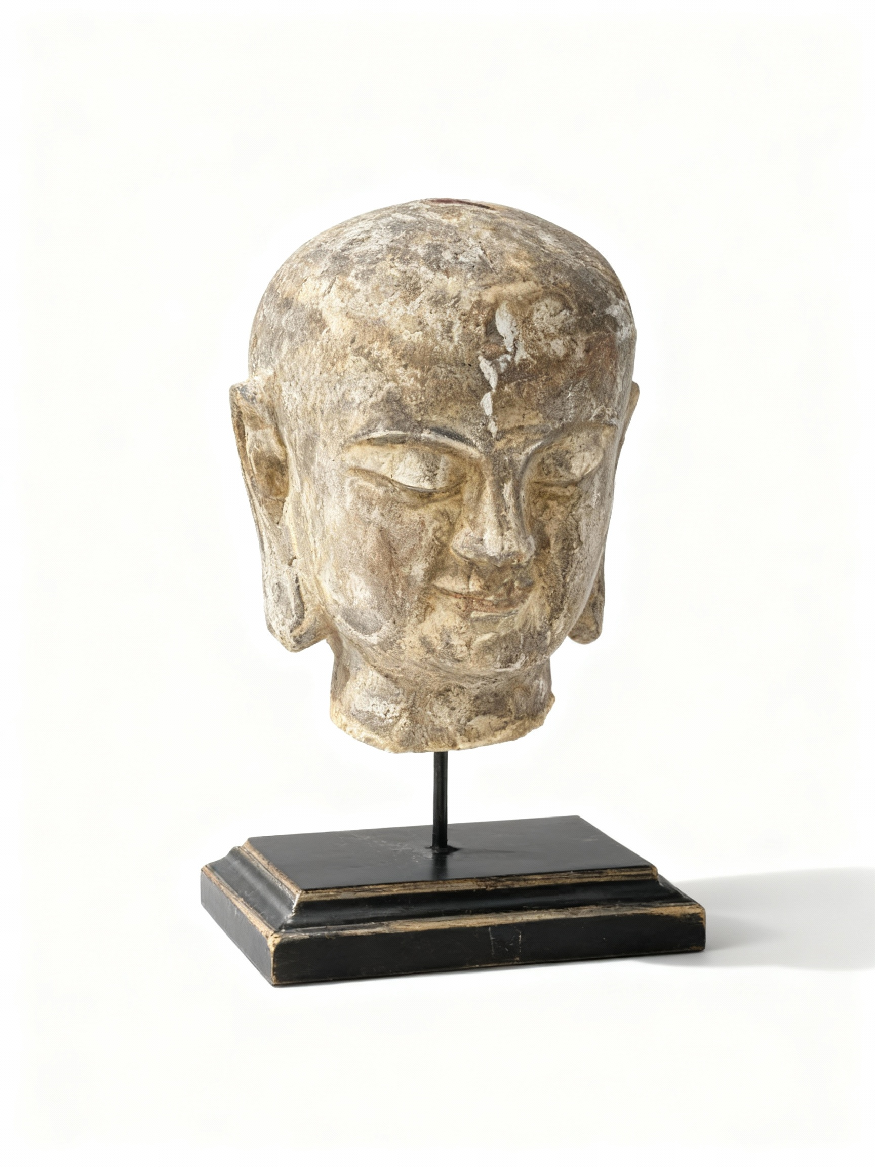 Elegant Asian statue head on a black pedestal, featuring soft lines, a meditative expression, and an aged, authentic patina