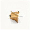 Square glass-top coffee table on a gold, black and steel sculptural base
