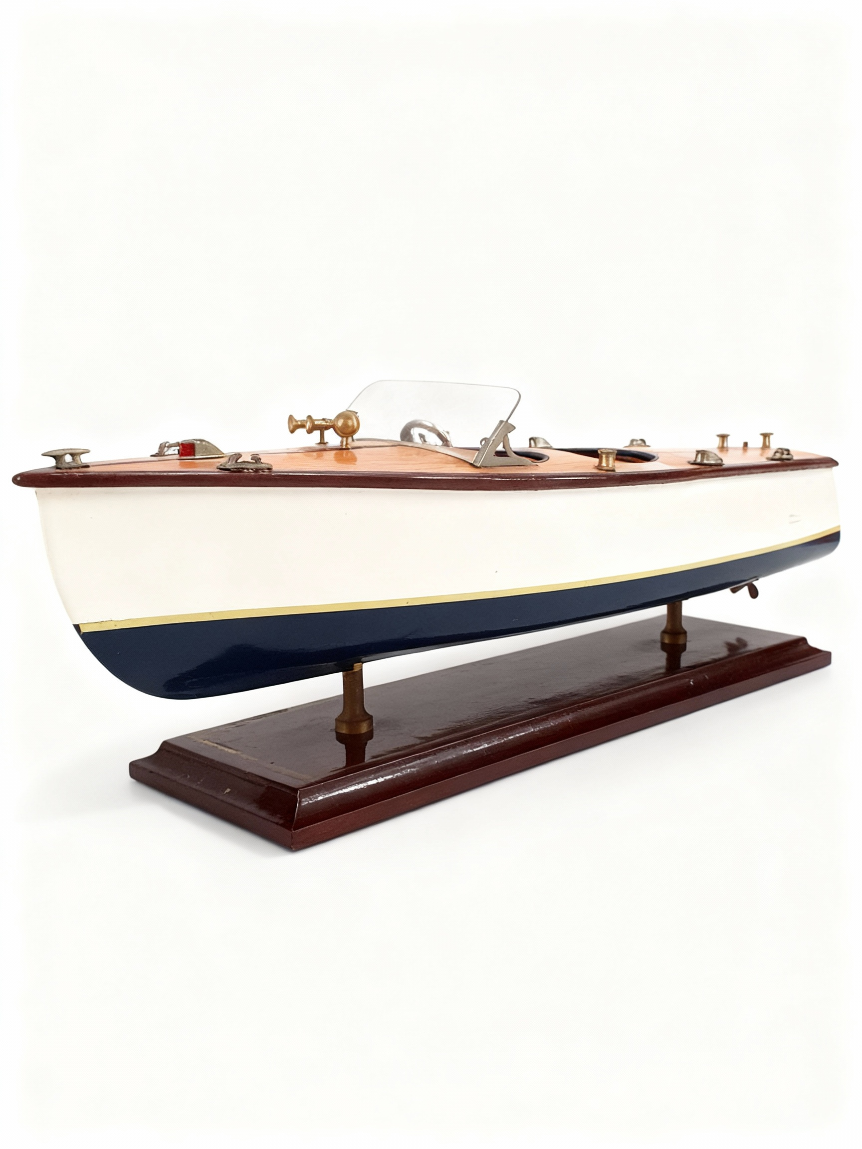 L'Aquarama Vintage decorative model boat with varnished wood effect deck, white and blue hull, and polished brass details on dark base
