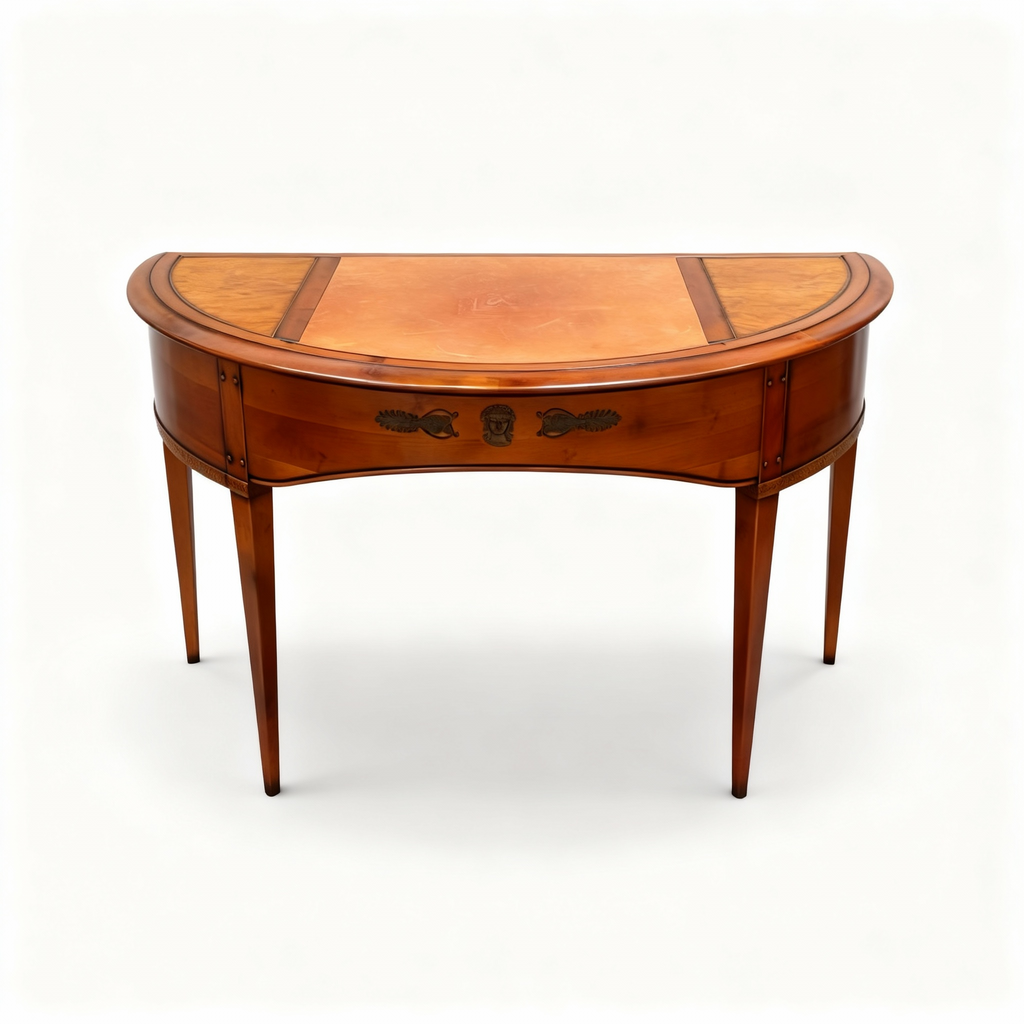 Elegant Louis XVI style half-moon writing desk made of warm cherrywood, featuring tapered legs, brass fittings, and a top covered with genuine leather.