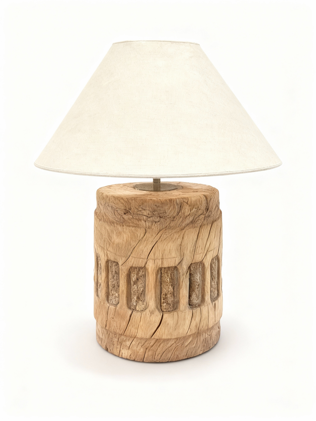 Table lamp with a raw, cylindrical solid wood base featuring carved patterns, natural cracks, and topped with an ecru conical fabric lampshade