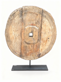 Antique patinated wood cart wheel sculpture on a black metal stand, 55 cm