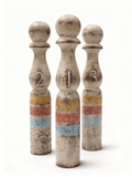 Set of three vintage bowling pin sculptures with faded colour bands and rustic patina