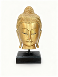 Thai-style gilded Buddha head sculpture with smooth golden finish on a black pedestal