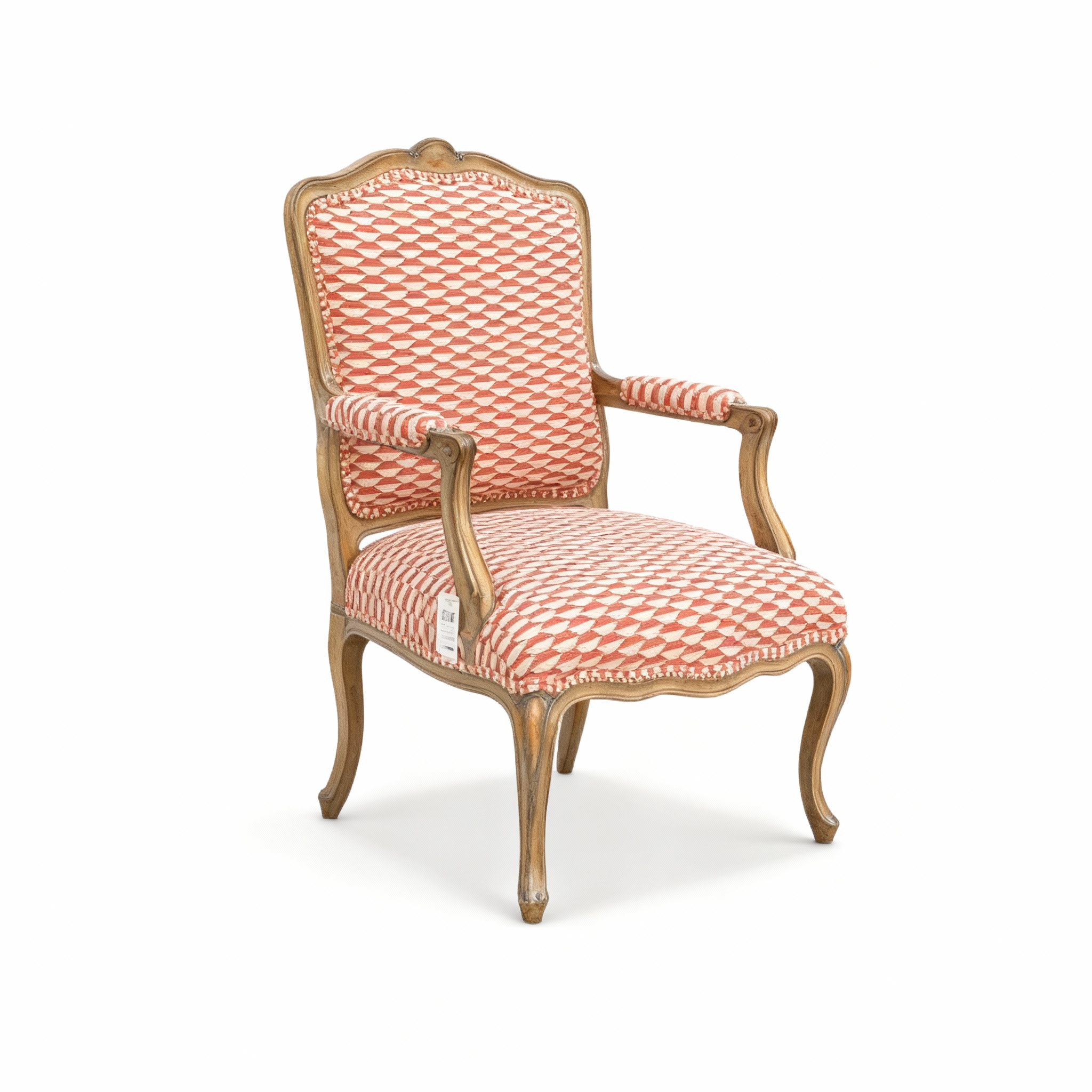 Louis XV style "Versailles" armchair with a carved, patinated wood frame and a high à la Reine backrest, upholstered in striking red/coral and off-white geometric fabric.
