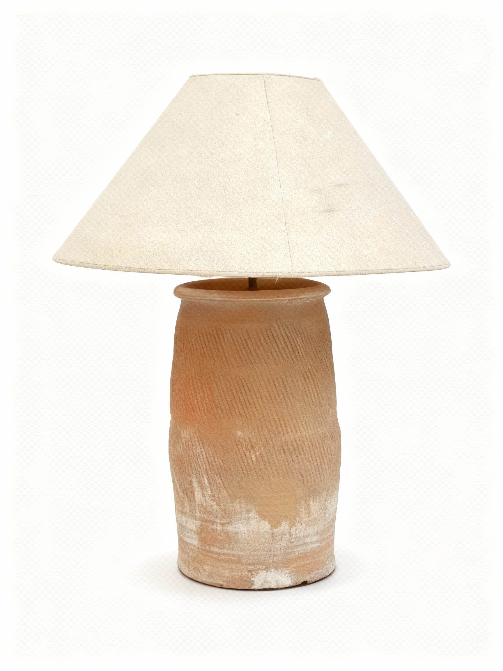 Table lamp with a round terracotta base featuring diagonal grooves and a unique whitewashed patina, topped with a clean ecru conical lampshade