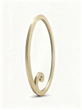 XXL oval sculptural mirror with brushed gold brass frame on a wall